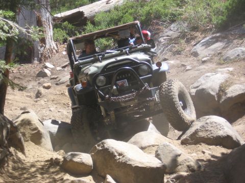 1994 Ford Bronco - This Toyota Land Cruiser FJ40 tackles a challenging rocky terrain, demonstrating its off-road capabilities.