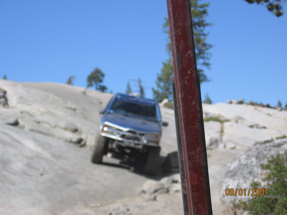 Blue lifted 4x4 SUV crawling down a granite slab off-road trail, dated 09/01/2007