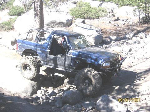 1994 Ford Bronco - This modified SUV navigates a rocky trail, its off-road capabilities.