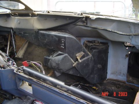 1989 Ford Bronco - The interior of a vehicle shows significant disassembly, with wiring and HVAC components exposed.