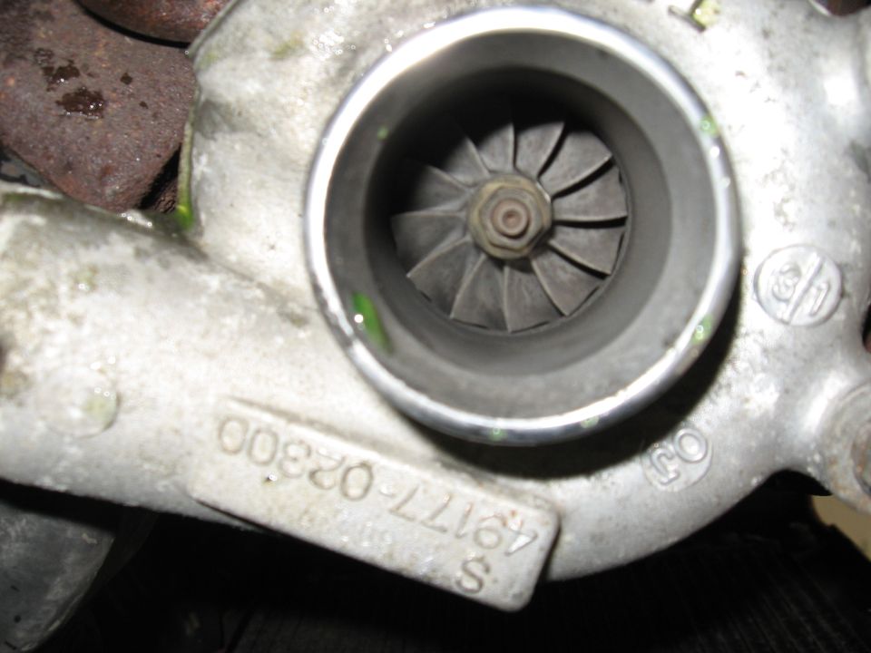 Close-up of a turbocharger with visible part numbers 'S 49177-02300' and '008200'