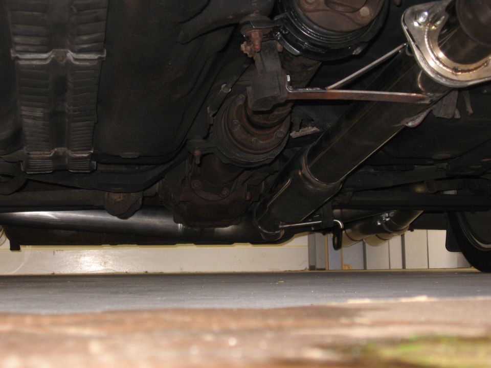 Undercarriage of a vehicle showing the exhaust system and drivetrain components