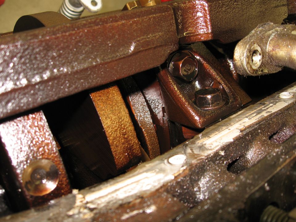 Engine crankshaft with connecting rods visible inside the engine block