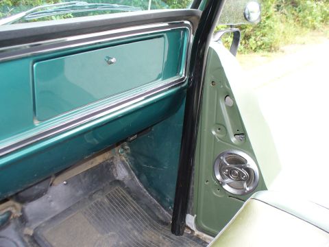 1978 Ford Bronco - Interior view of a 1978 Ford Bronco, showing the door panel, dashboard, and speaker.