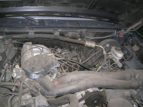 1985 Ford Bronco - The engine bay of a Ford truck, likely from the late 1980s, is shown with various components and hoses visible.