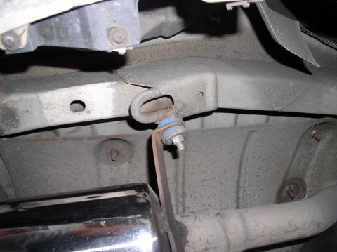 1994 Ford Probe - Close-up view of a vehicle's exhaust system component and its mounting hardware.