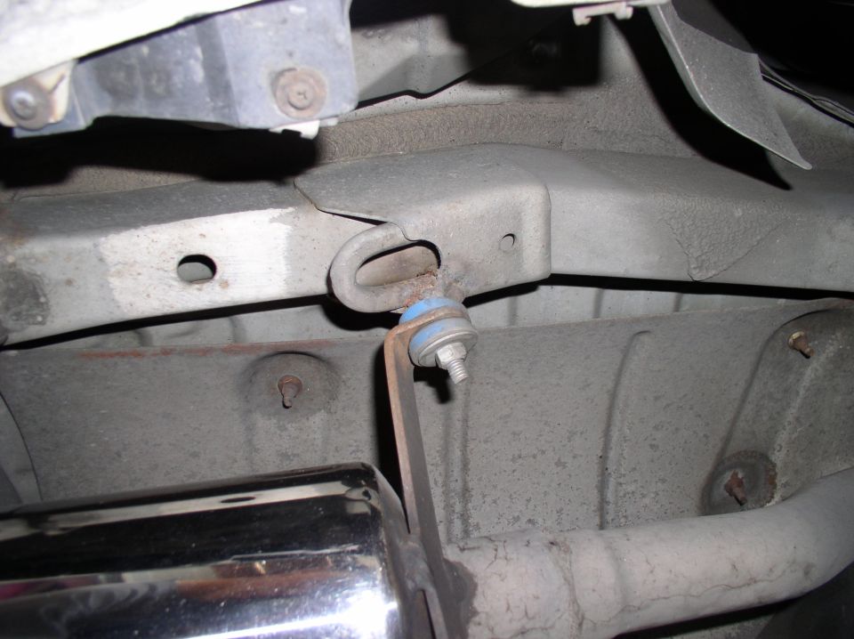 Chrome exhaust tip and mounting bracket attached to vehicle undercarriage