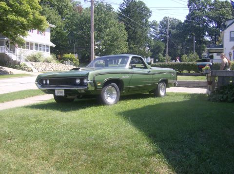 1970 Ford Ranchero - This 1970 Ford Ranchero features a distinctive hood scoop and is parked on a grassy lawn.