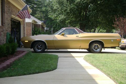 1972 Ford Ranchero - A gold 1972 Ford Ranchero is parked in a driveway next to a brick house.