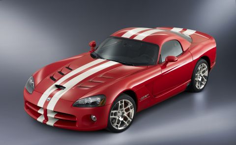 1991 Mazda RX-7 - A red sports car with white racing stripes is shown from a 3/4 front angle against a grey background.
