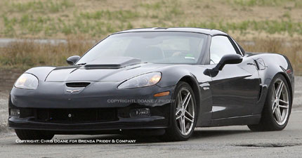1991 Mazda RX-7 - A black Chevrolet Corvette C6 is shown from a three-quarter front view, a prominent hood scoop.