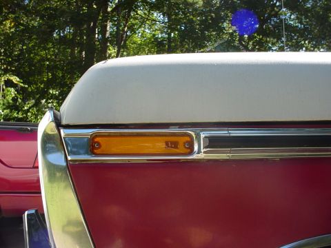1978 Ford Bronco - Side marker light detail on a 1978 Ford Bronco, with another vehicle visible to the left.
