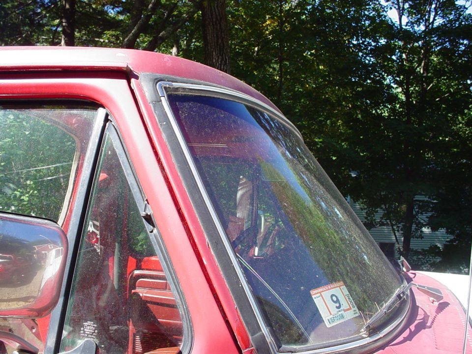 1978 Ford Bronco interior showing red seats and dashboard through the windshield