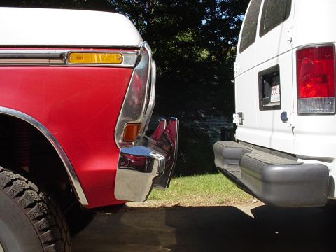 1978 Ford Bronco - Two vehicles are parked closely together, showing their front and rear ends respectively.