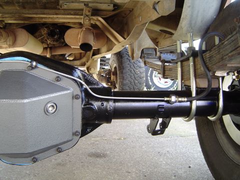 1978 Ford Bronco - Close-up view of the rear axle assembly, including the differential cover and leaf springs, on a vehicle.