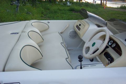 1985 Carver 326 Aft Cabin - Interior view of a boat showing seating, dashboard, and steering wheel.