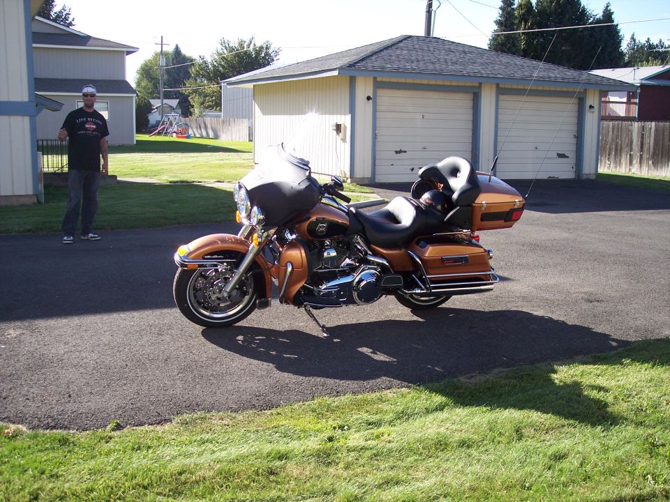 Orange Harley-Davidson motorcycle parked in driveway