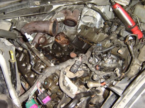 1992 Ford Bronco - A close-up view of a complex engine compartment with numerous wires and mechanical parts visible.