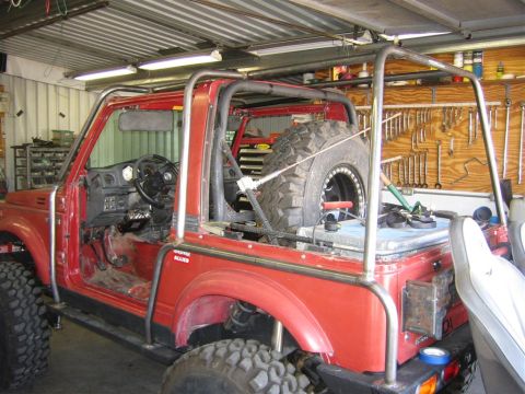 1987 Suzuki Samurai - This modified 1987 Suzuki Samurai features a substantial external roll cage and is equipped for off-road use.