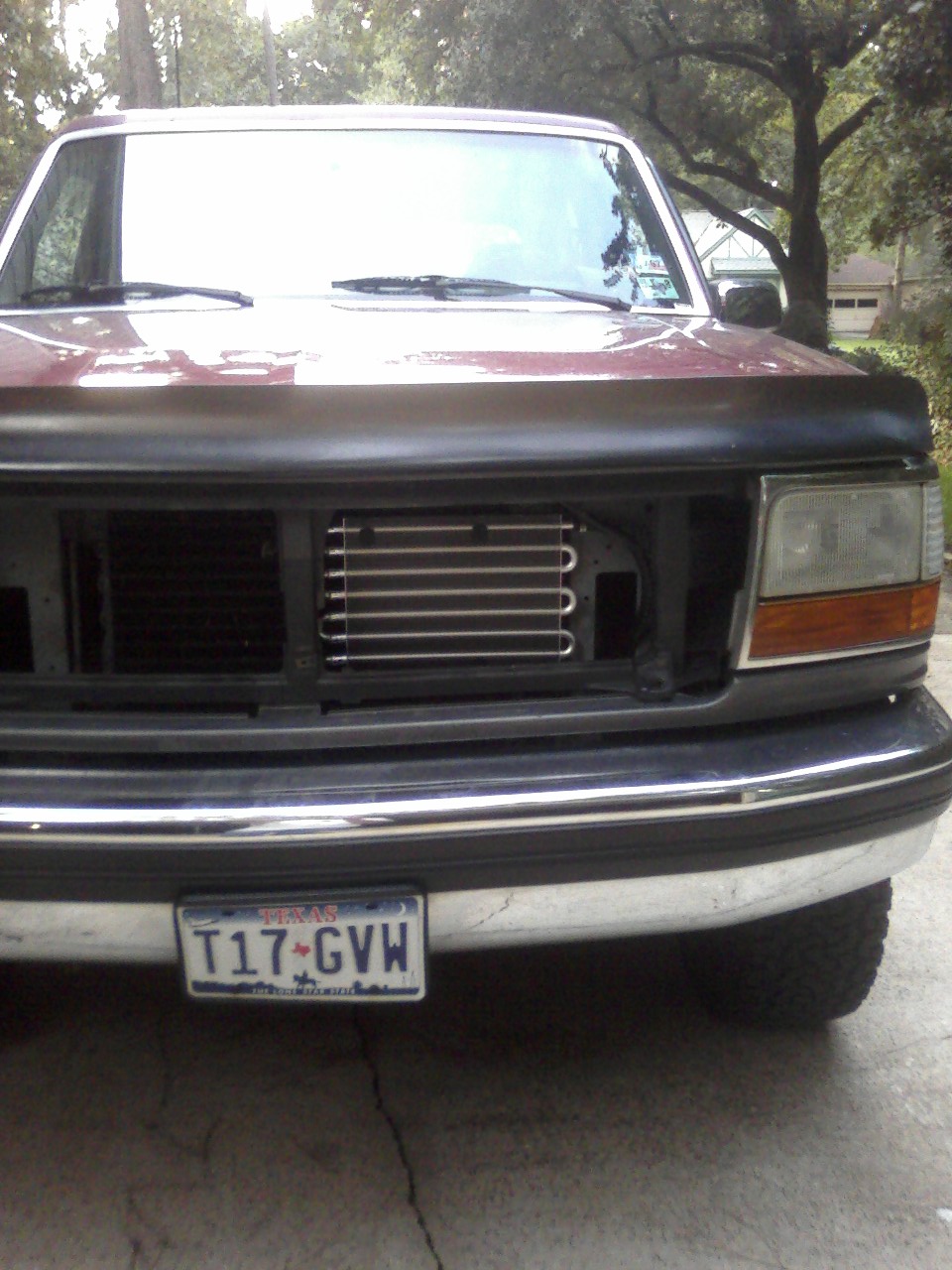 Front of a 1993 Ford Bronco with aftermarket transmission cooler and Texas license plate T17-GVW