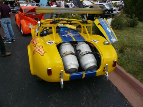 1975 Ford Ranchero - This custom yellow race car has propane tanks visible in its open rear compartment.