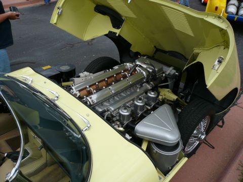 1975 Ford Ranchero - The V12 engine of a 1965 Jaguar E-Type is visible with the hood open.