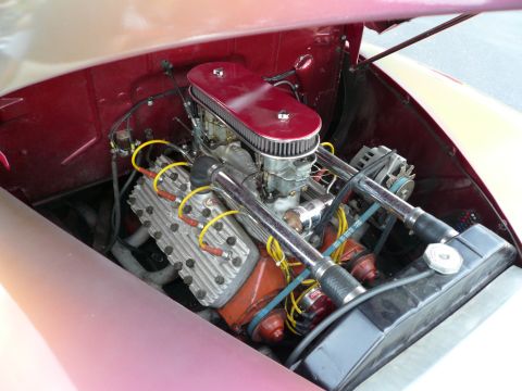 1975 Ford Ranchero - Close-up view of a classic car's V8 engine, chrome accents and a red air filter housing.