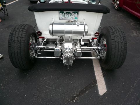 1975 Ford Ranchero - Rear view of a custom hot rod with a "STRIP-T COLORADO" license plate and exposed drivetrain.