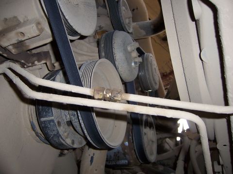 1991 Ford Bronco - A close-up view of engine belts and pulleys, covered in dust.
