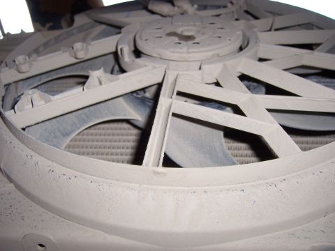 1991 Ford Bronco - The radiator fan shroud is covered in a layer of dust, obscuring the details of the fan and radiator behind it.