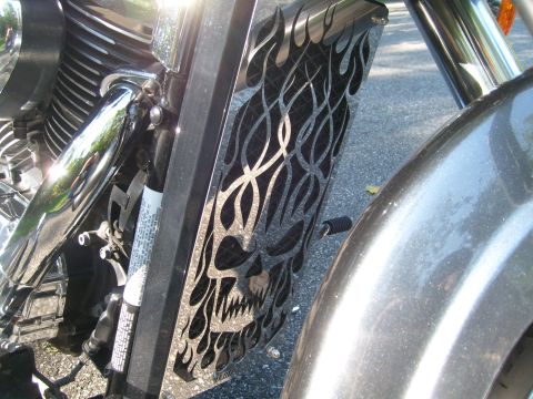 1993 Ford Bronco - Close-up of a motorcycle's radiator cover a custom graphic of a skull with flames.
