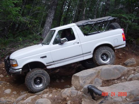 1989 Ford Bronco - Rear tire climbed up on the rock