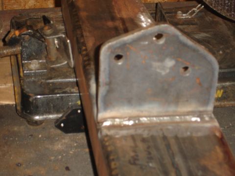 1989 Ford Bronco - A close-up view of a custom-fabricated metal bracket, showing welds and mounting holes.