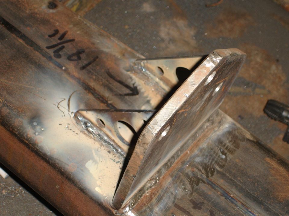 Welded metal bracket with handwritten measurements '1/2' and '61' marked on it