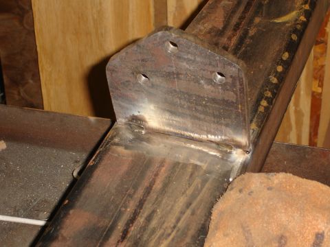 1989 Ford Bronco - A metal bracket is welded to a steel beam, showing the construction detail.