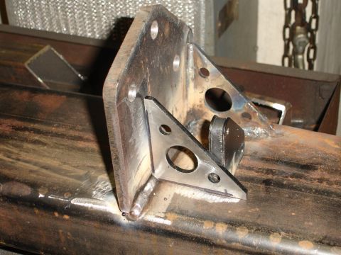 1989 Ford Bronco - Close-up of a custom-fabricated metal bracket, welded onto a steel tube, possibly for a rear bumper assembly.