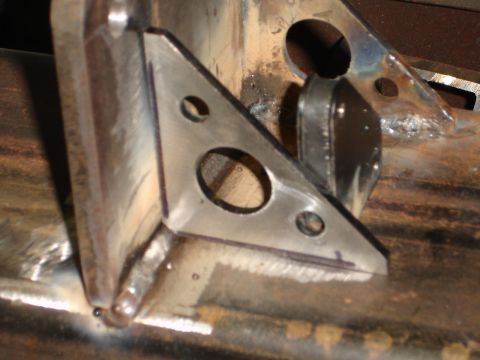 1989 Ford Bronco - Close-up of a metal bracket with multiple holes, likely for a custom rear bumper fabrication.
