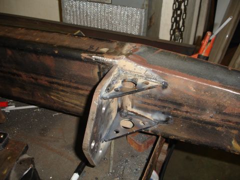 1989 Ford Bronco - Custom steel bracket welded onto a rusty frame section, likely for a bumper build.