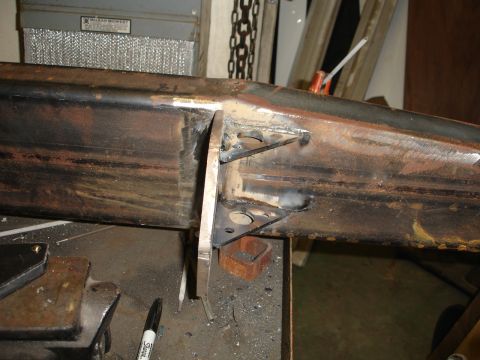1989 Ford Bronco - Close-up of metal fabrication and welding on a rusty steel structure in a workshop setting.