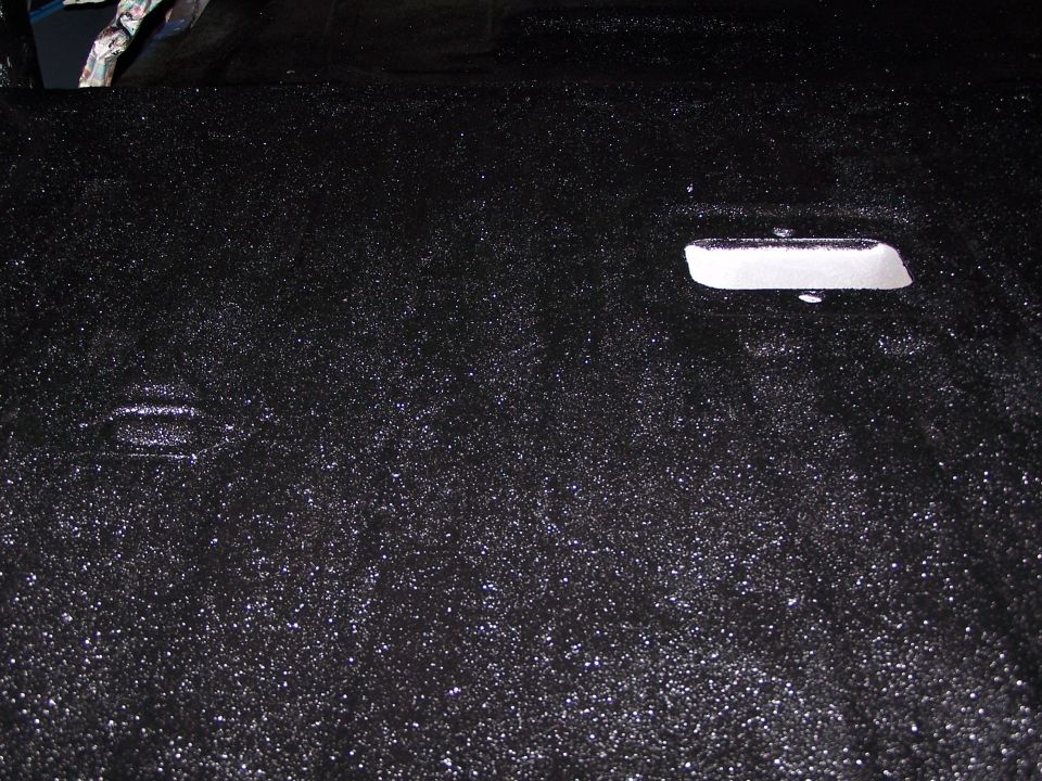 Black carpeted vehicle interior floor or cargo area