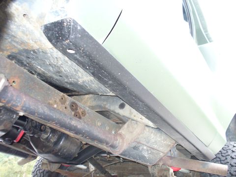 1978 Ford Bronco - Close-up of the rocker guard and undercarriage, revealing frame details and potential rust.