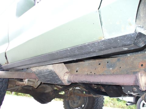 1978 Ford Bronco - Undercarriage view of a vehicle, focusing on the rocker panel and frame components.