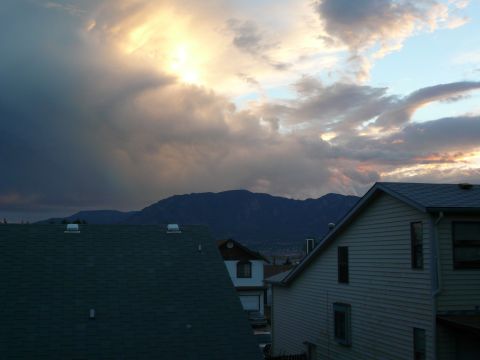 1975 Ford Ranchero - Dramatic sky with sunbeams illuminates houses and distant mountains.