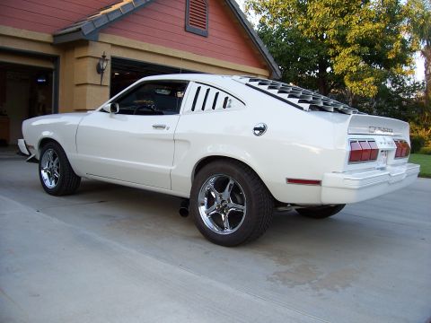 1978 Ford Mustang II - White 1978 Ford Mustang II coupe parked in driveway, showing off its distinctive rear louvers.