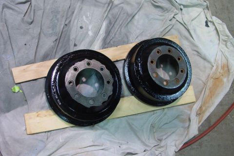 1993 Ford Bronco - Two brake drums, likely for a classic vehicle, are shown after being painted.