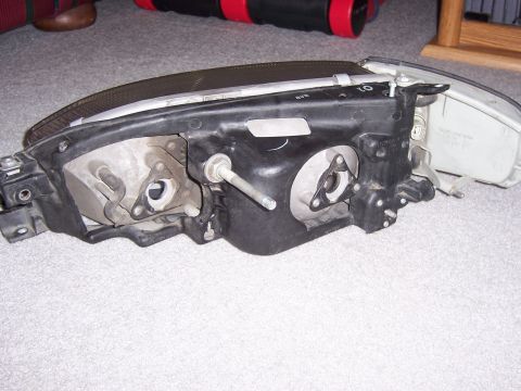 1987 Volkswagen Golf - This is a headlight assembly, not a 1987 Volkswagen Golf. The part is shown from the side with its internal mounting points visible.