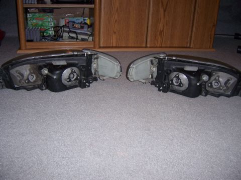1987 Volkswagen Golf - A pair of car headlights are shown from the back, resting on a carpeted surface.