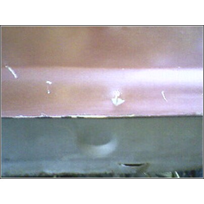 1973 Ford Ranchero - Close-up view of a vehicle's tailgate, showing paint chips and the lower section.