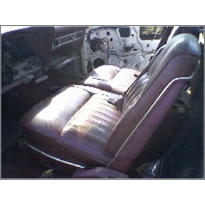 1973 Ford Ranchero - Interior view of a car's burgundy seats and door panel, showing signs of wear.