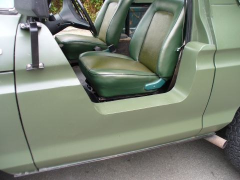 1978 Ford Bronco - Interior view of a vehicle with green seats and door panels, showing the driver's side.